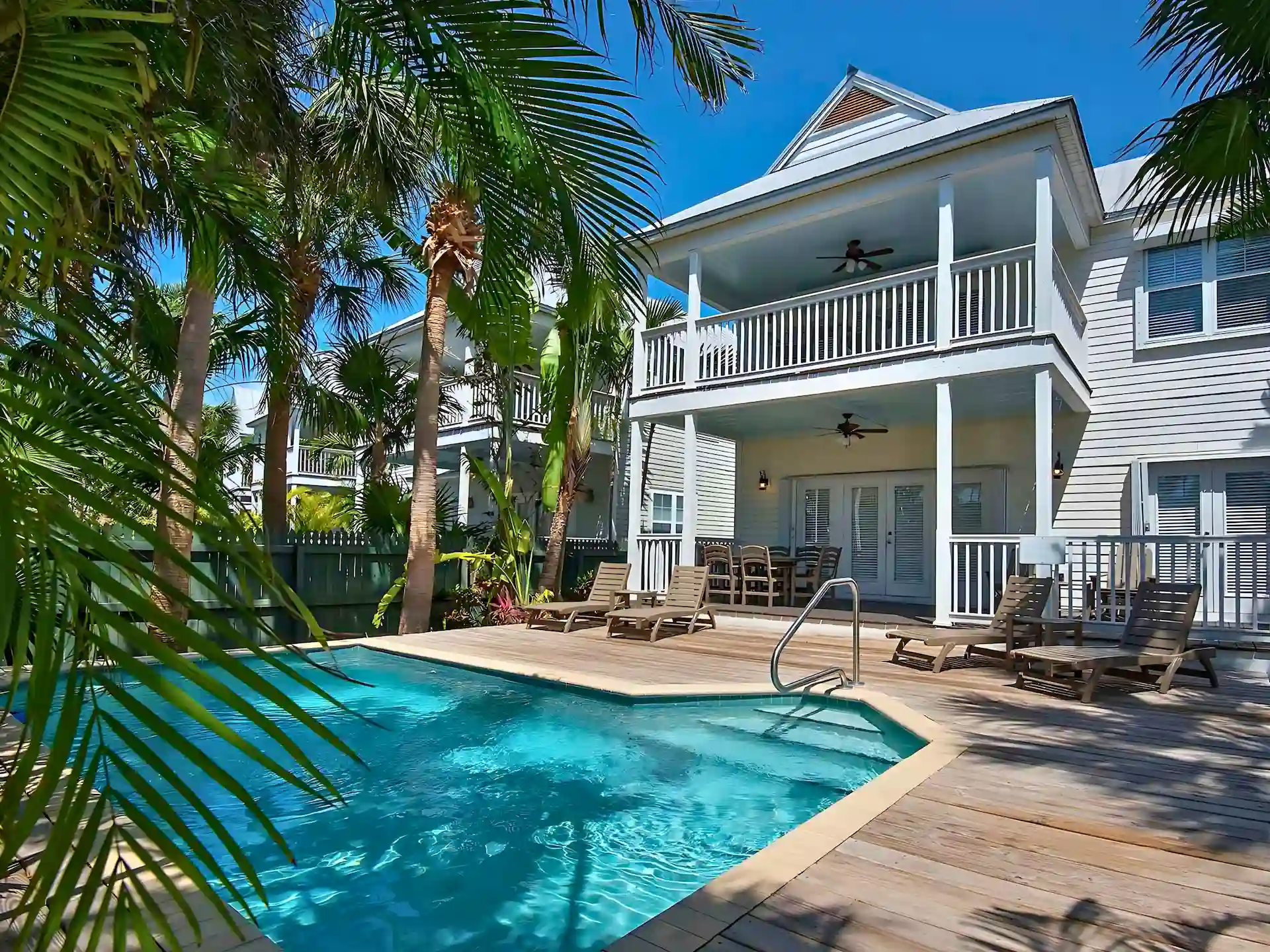 Tropical villa with private pool, palm trees, and balconies at Hawks Cay Resort.